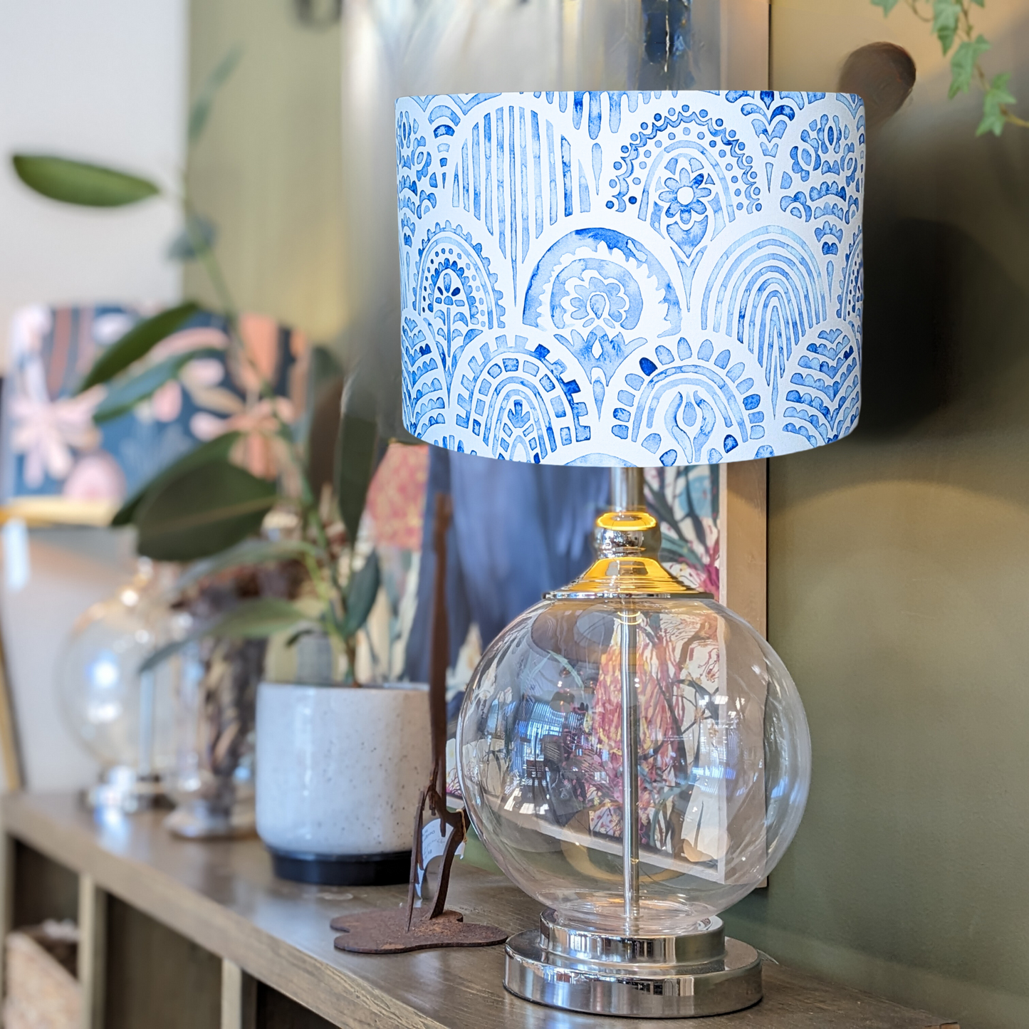 Emotive Collection’s handmade Blue & White Hamptons lampshade on a glass base, designed with tranquil coastal motifs in a blue and white palette. Expertly crafted in Australia.