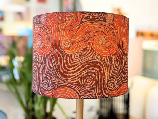 The Indigenous Aboriginal Warlu Mina Mina Dreaming Lampshade by artist Pauline Napangardi Gallagher features an intricate, abstract pattern in warm reds, oranges, and browns with swirling lines and dot motifs inspired by Aboriginal art.