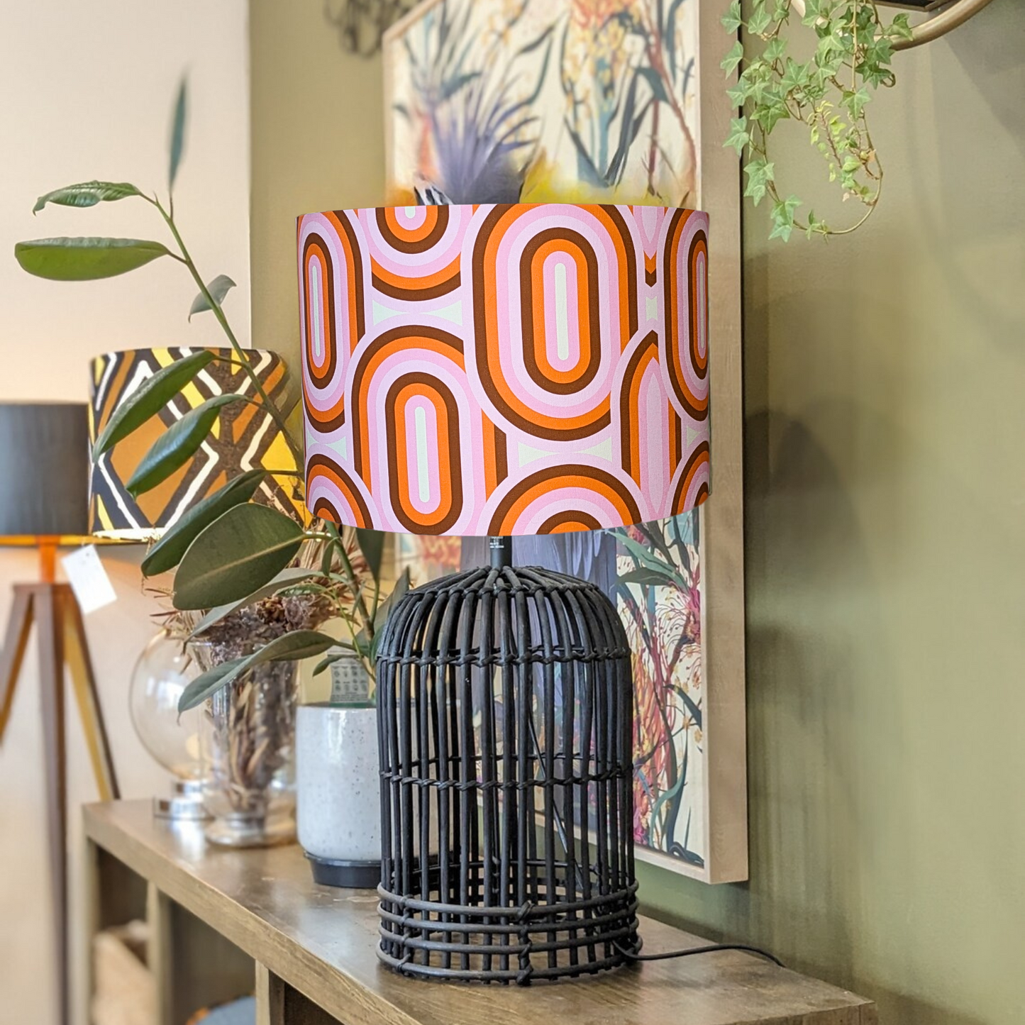 Handmade 70's retro lampshade with eye-catching, vibrant patterns and a nostalgic vibe. Shown on a Black rattan lamp base. Crafted in Australia by Emotive Collection for a timeless design.