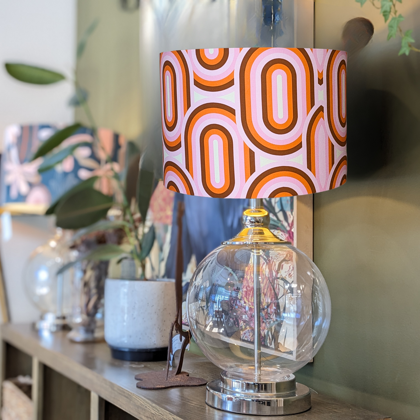 Emotive Collection’s 70's retro lampshade on a glass base, designed with bright, geometric patterns and bold hues. Handcrafted in Australia for a unique, vintage-inspired lighting accent