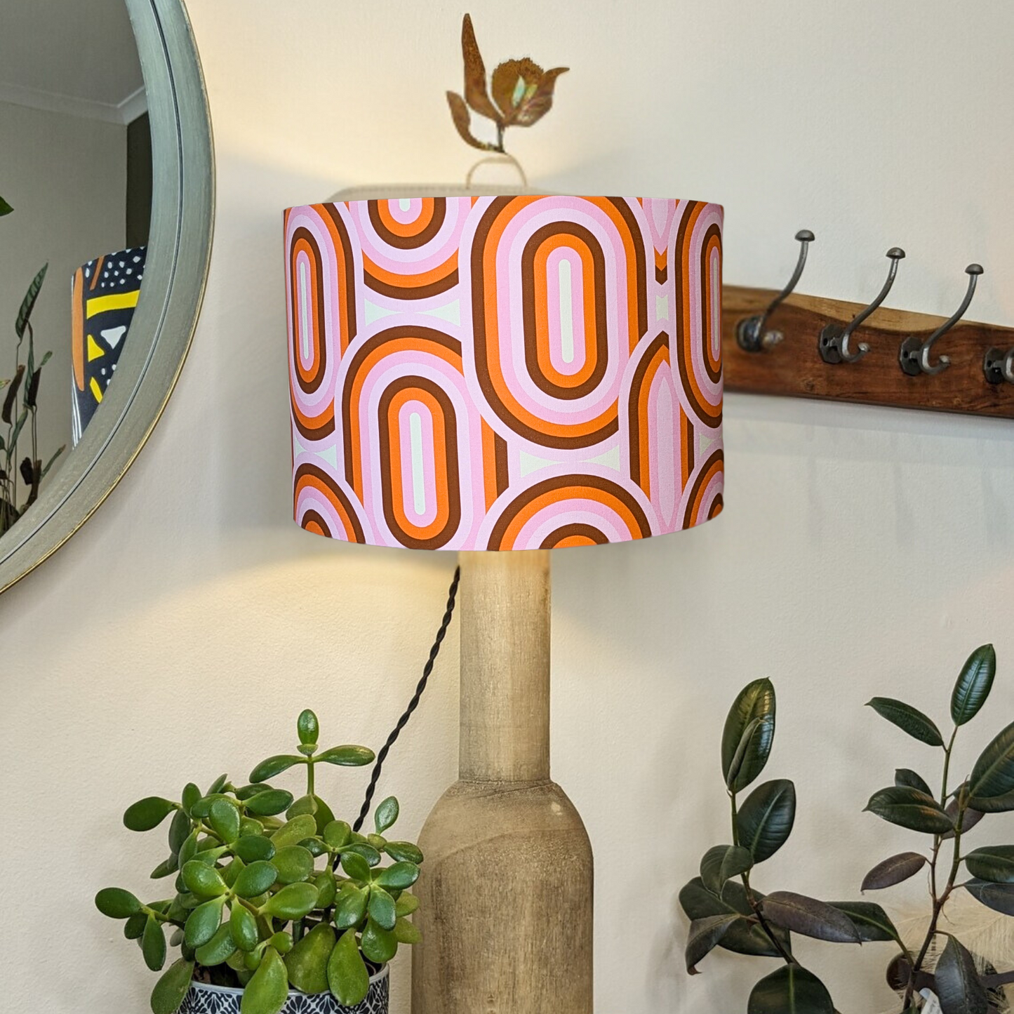 Bold 70's retro lampshade by Emotive Collection on a wooden lamp base with the light switched on, showcasing vintage-inspired designs and vibrant colors. Expertly handmade in Australia for a distinctive style