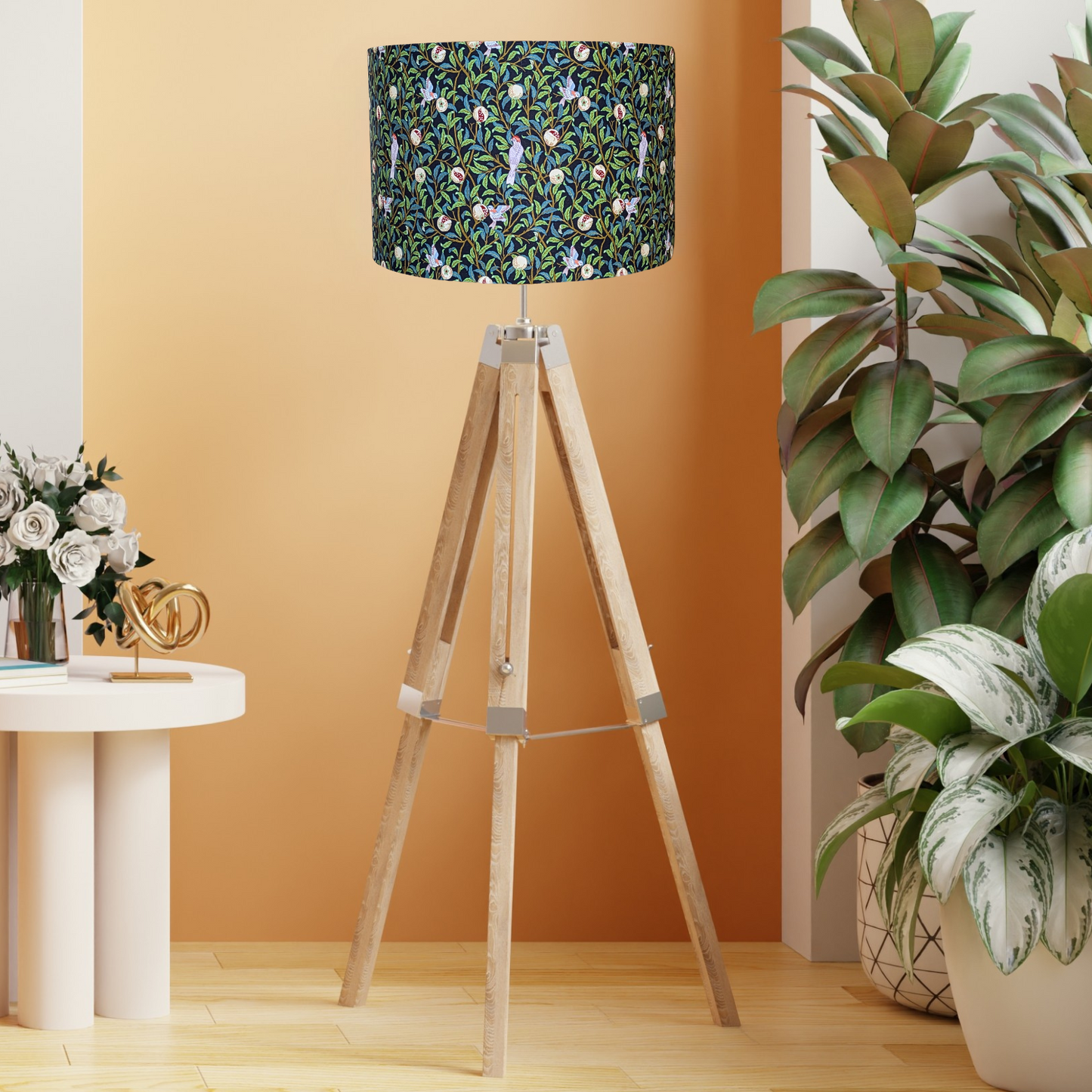 Full view of the Bird & Pomegranate Black lampshade by Emotive Collection, shown on a wooden tripod floor lamp, with a striking design of birds and pomegranates on a contrasting black background. Handmade in Australia for a unique lighting experience.