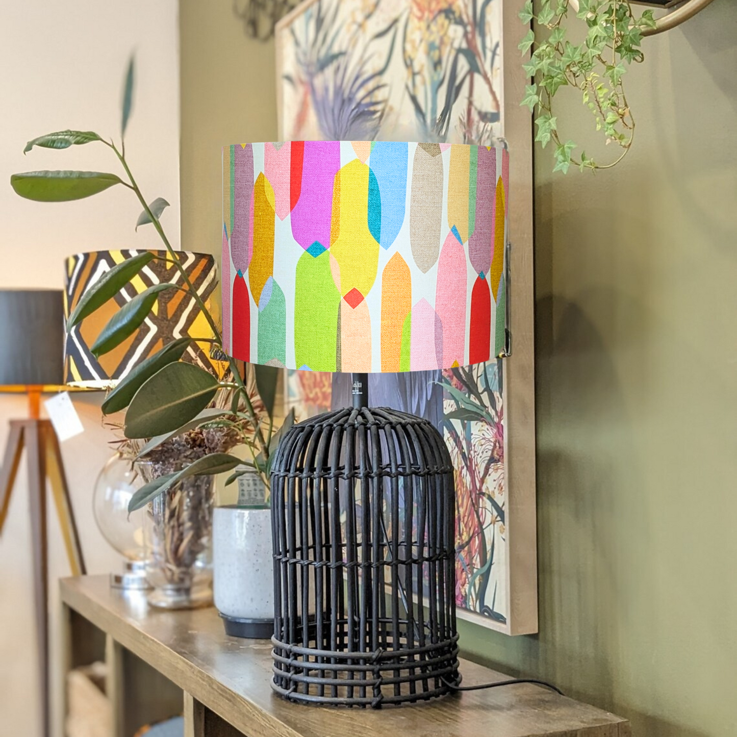 Emotive Collection's Multi-Colour Mid-Century lampshade on a Black wooden lamp base, featuring a lively design by Australian artist Cecilia Mok. Crafted in Australia using premium materials for a striking, contemporary look.