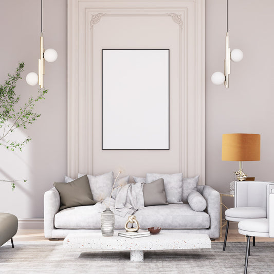Elegant living room with a light gray sofa, neutral pillows, and modern coffee table. A blank frame hangs above, while pendant lights and the Emotive Collection’s Dark Mustard Premium Linen Lampshade warm the minimalist decor.