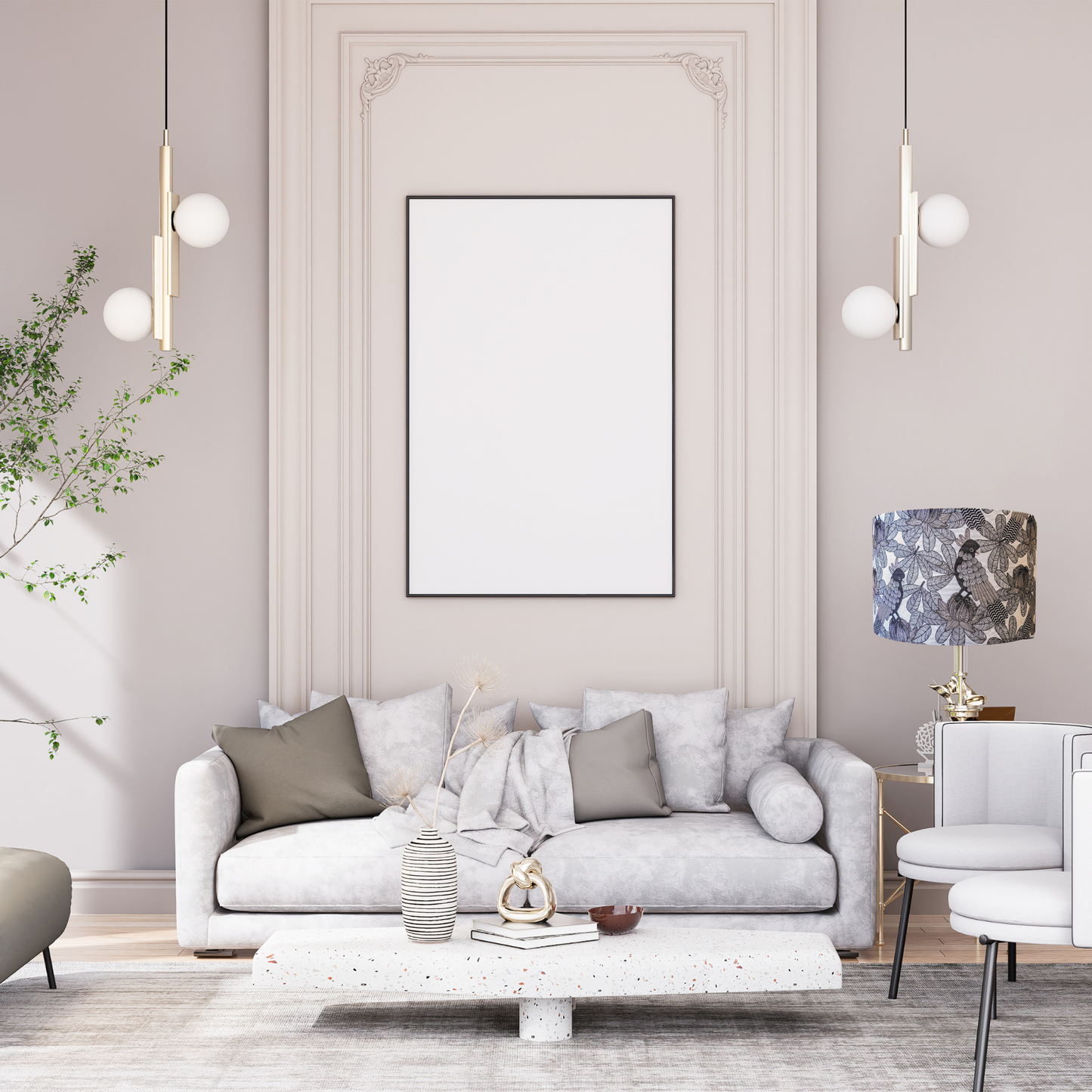 A modern living room features a light gray sofa, assorted cushions, a terrazzo coffee table, and a blank frame. Pendant lights and the Emotive Collection’s Australian Cockatoo Lampshade add plants and neutral Australian designer accents.