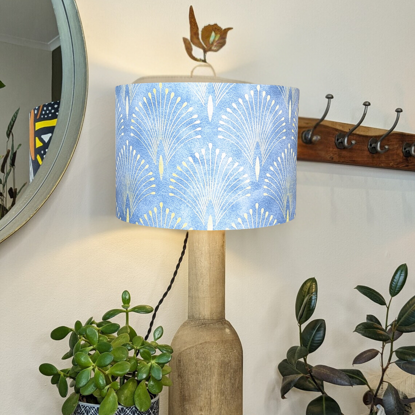 Handmade Gatsby lampshade by Emotive Collection on a wooden base, designed with an iconic Gatsby print against a vibrant blue backdrop. A one-of-a-kind lighting accessory, crafted with care in Australia