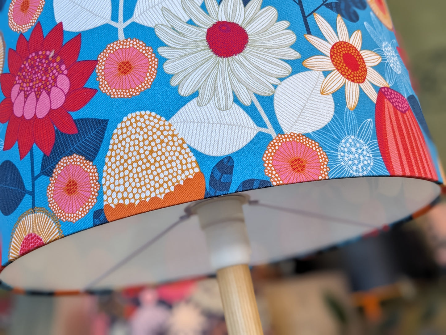 Close up of the lampshade fitting for Handmade Banksia Grove lampshade by Emotive Collection, featuring an exquisite design by Jocelyn Proust, with vibrant Banksia flower illustrations. Crafted in Australia for a touch of natural elegance.