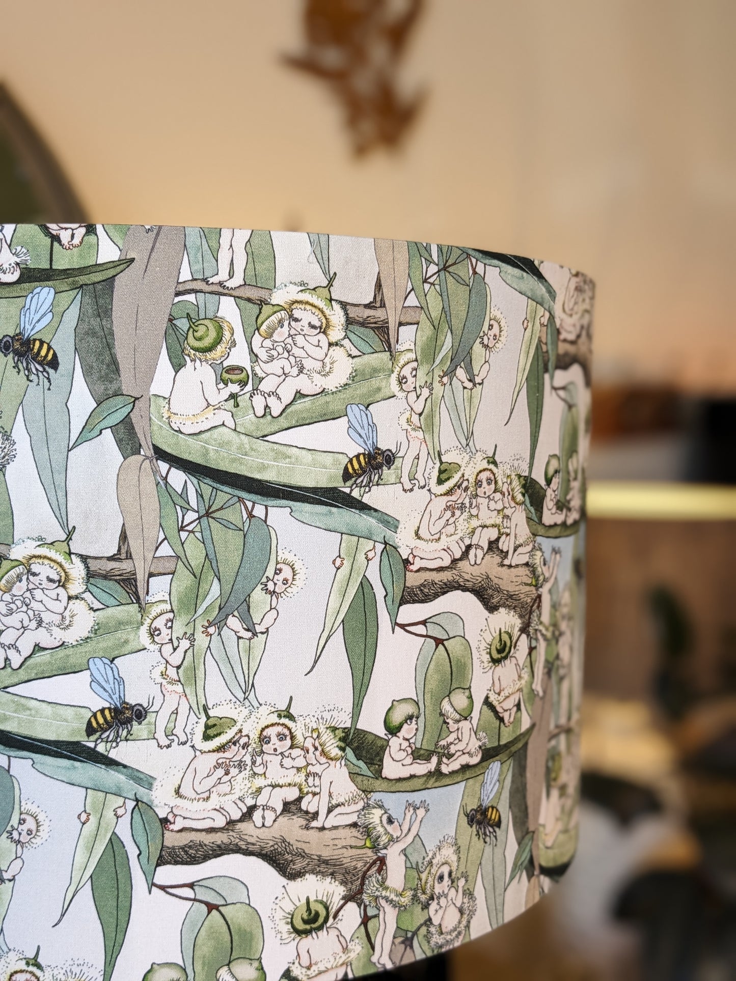 Side view of the Vintage May Gibbs lampshade by Emotive Collection, featuring Snugglepot and Cuddlepie with Australian flora on a yellow backdrop. A delightful, handmade piece crafted in Australia to bring warmth and nostalgia to your space.