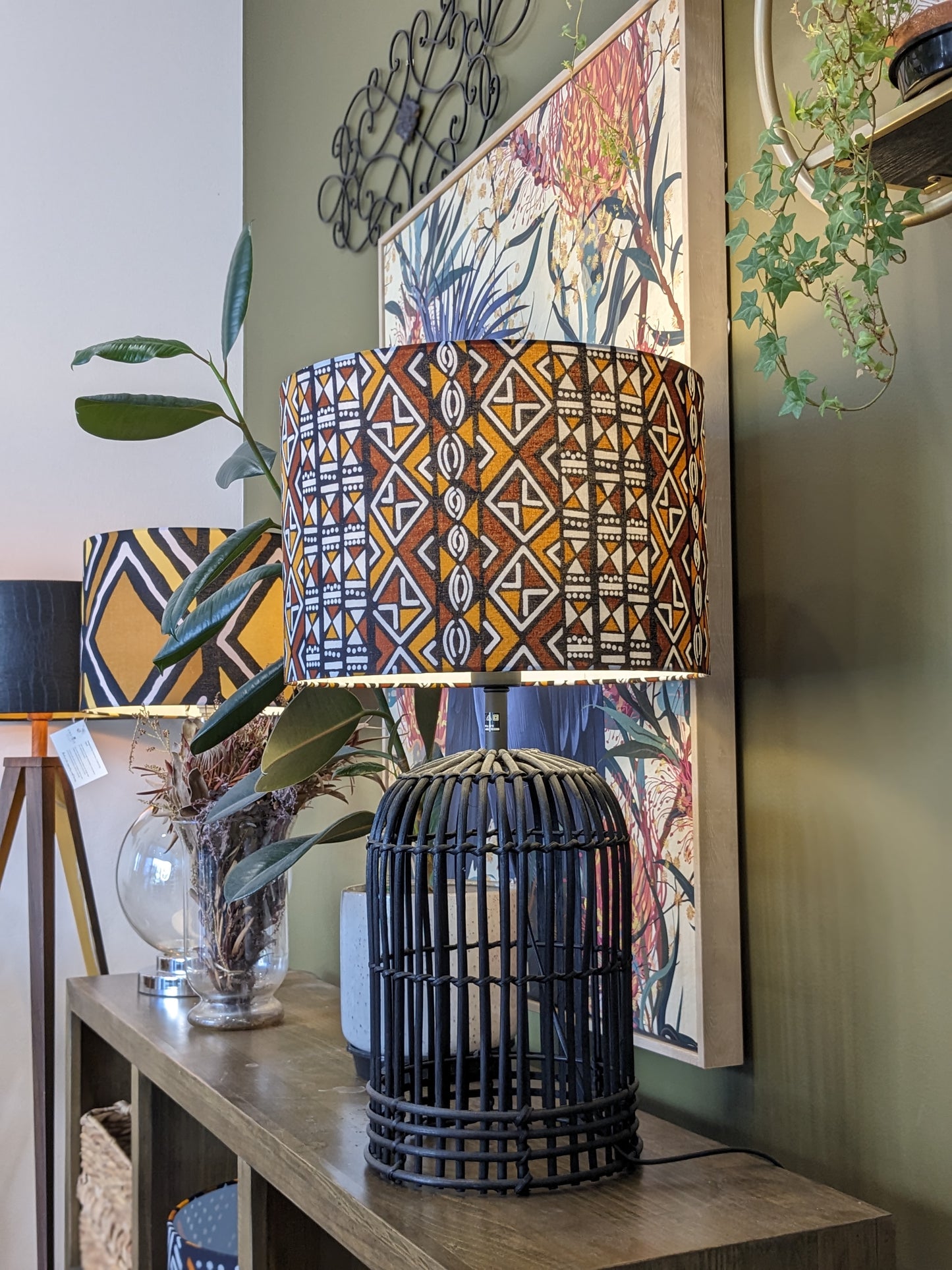 Handmade African Bogolan lampshade by Emotive Collection on a Black rattan base, made with authentic Bogolan mudcloth fabric and featuring traditional African motifs. Crafted in Australia for an elegant, artisan finish in any room.
