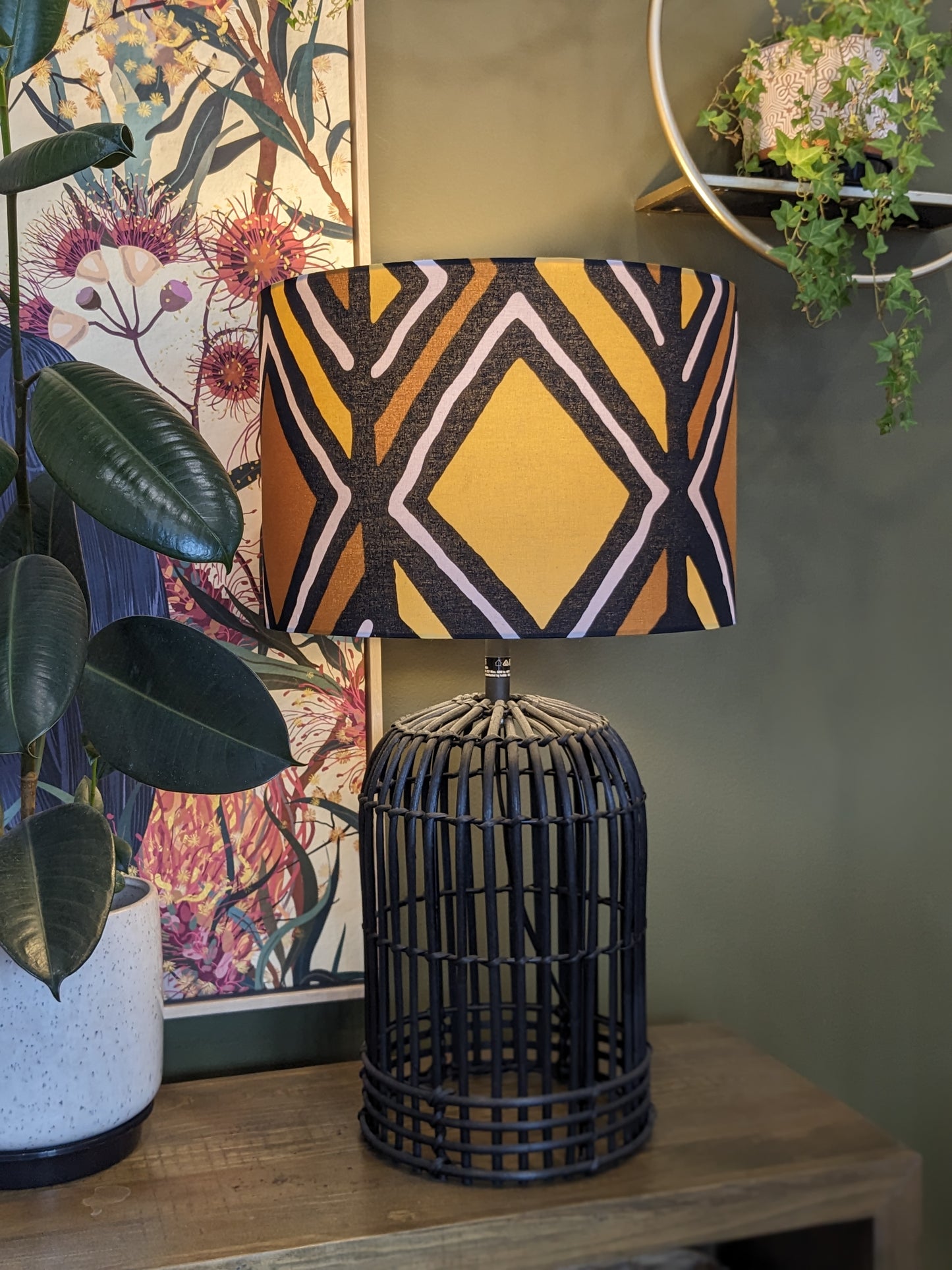 Handmade Traditional Mali lampshade by Emotive Collection on a Black rattan base, featuring a beautiful Malinese design on authentic Bogolan mudcloth fabric. This cultural masterpiece is crafted in Australia for an artisan touch in your home.