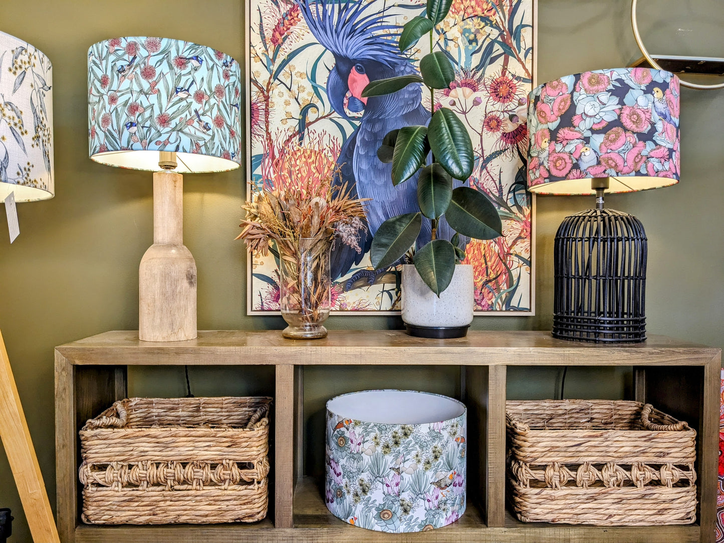 Vibrant Blue Wren & Hakea lampshade displayed on a wooden base on a sideboard, designed by Victoria McGrane from The Scenic Route and handmade in Australia. Showcasing Australian flora and fauna in a stunning design.
