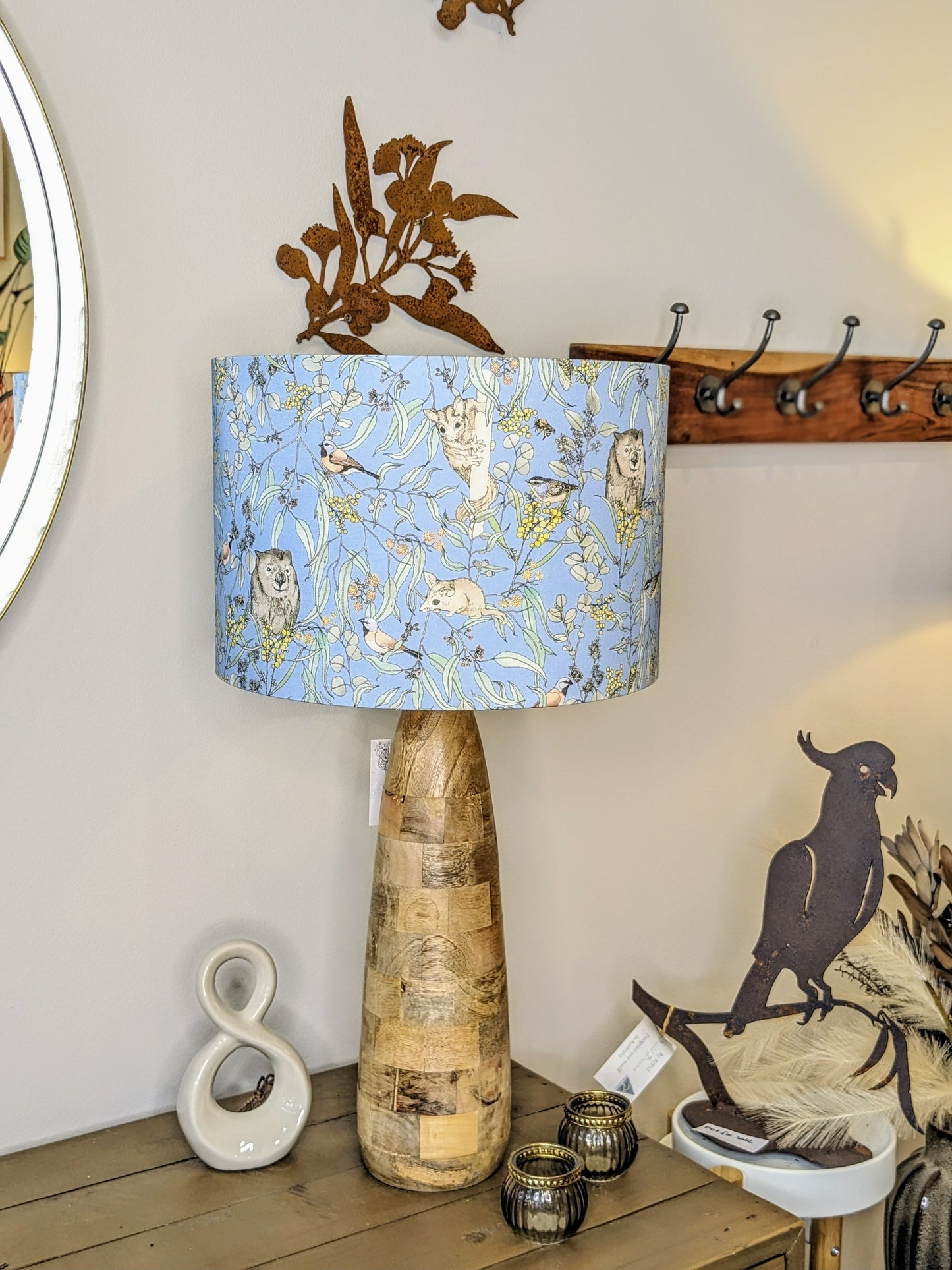 Handcrafted Wombat & Wattle lampshade by Emotive Collection, shown on a wooden lamp base, designed by Australian artist Victoria McGrane from The Scenic Route. A perfect blend of nature and artistry, made in Australia.