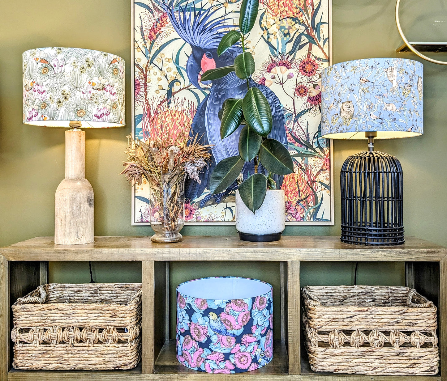 Zebra Finches lampshade on a wooden lamp base on a sideboard, showcasing a striking design of colorful finches by Australian artist Victoria McGrane. Handcrafted in Australia for a unique, nature-inspired touch