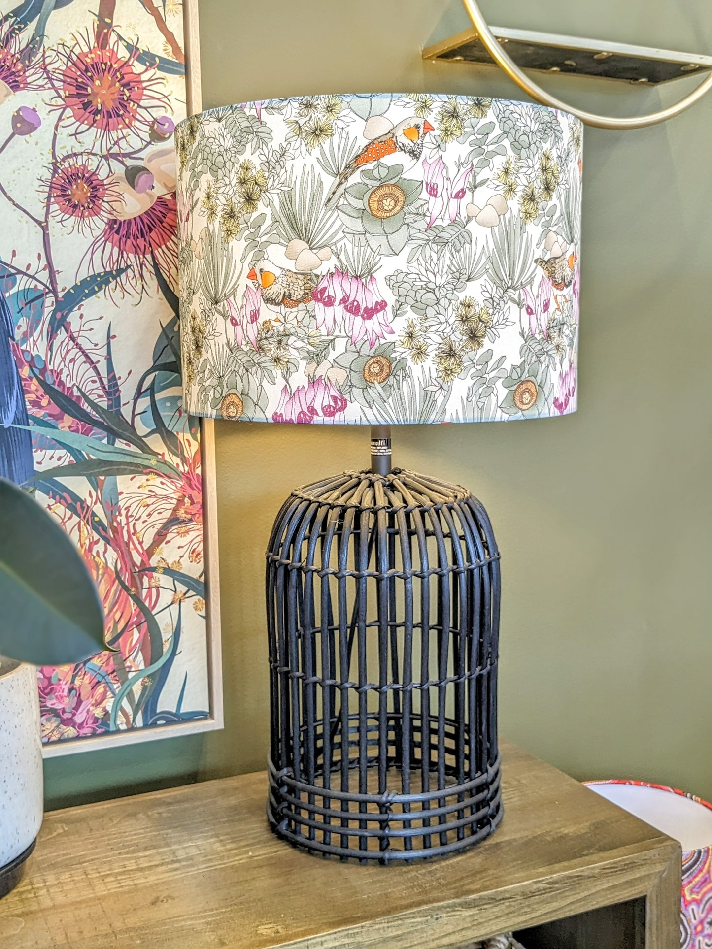 Emotive Collection's Zebra Finches lampshade on a Black lamp base, designed by Victoria McGrane from The Scenic Route, featuring vivid colors and intricate bird designs. Handmade in Australia for an artistic statement