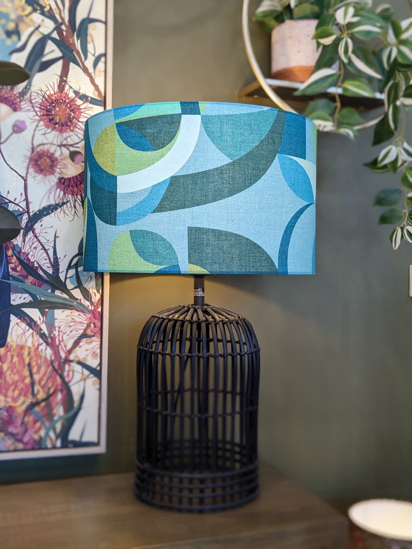 Modern Circles Teal lampshade by Emotive Collection on a Black rattan lamp base, designed by Australian artist Cecilia Mok. Featuring a contemporary pattern in rich teal hues, crafted by hand in Australia for a chic, modern touch