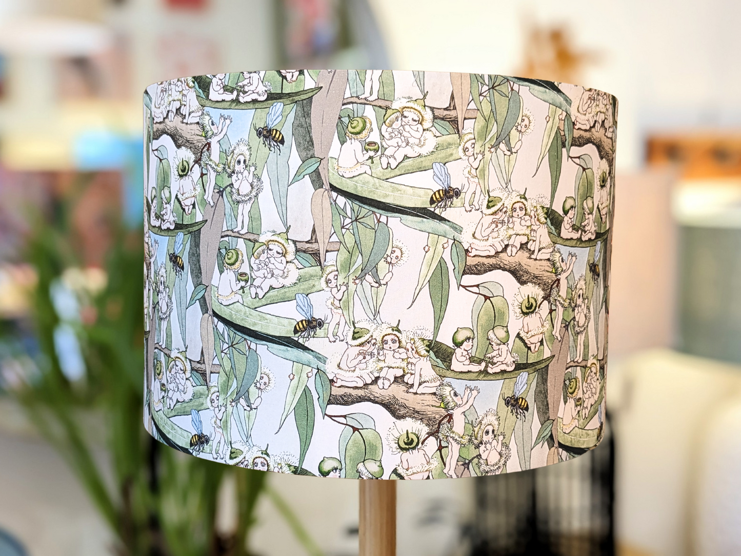 Handmade Vintage May Gibbs lampshade by Emotive Collection, featuring the classic Gumnuts and Snugglepot illustrations. Designed with a vibrant yellow background, it brings a nostalgic Australian charm to your home décor. Crafted in Australia.