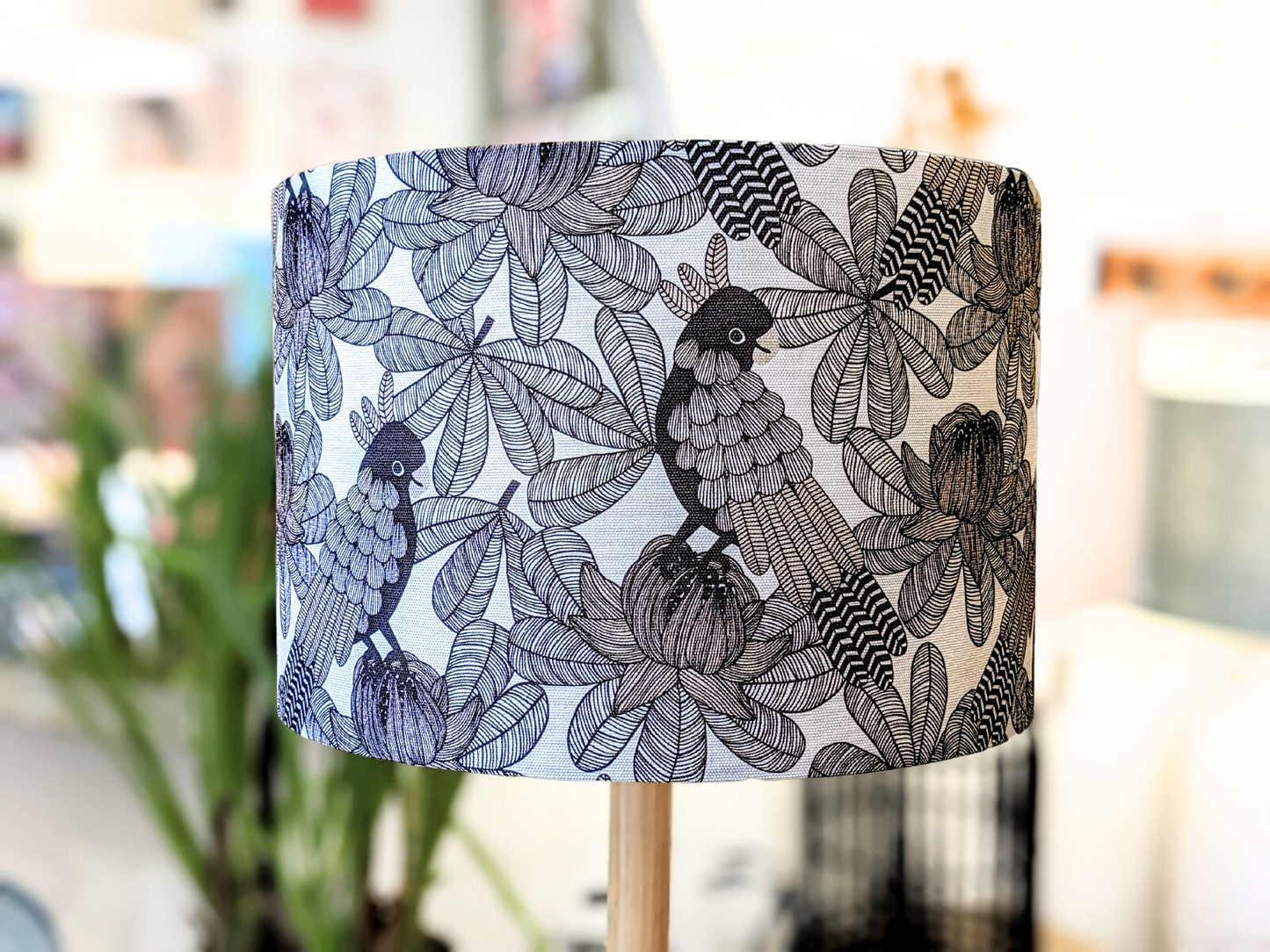 The Emotive Collection’s Australian Cockatoo Lampshade showcases a detailed black and white bird and leaf pattern by an Australian designer, with a softly blurred backdrop highlighting its intricate, almost abstract design.