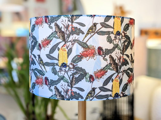 The Emotive Collection’s Yellow Banksia & Native Birds Lampshade is handmade with a vibrant design of native birds and banksia on white, creating a lively and colorful accent for any space.