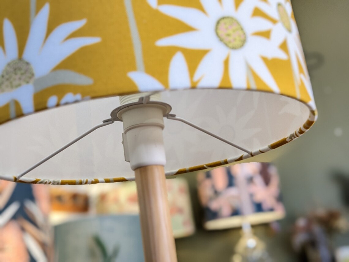 Close up of lampshade fitting of the handcrafted Flannel Flower Mustard lampshade by Jocelyn Proust, with vibrant mustard-colored flannel flower motifs. Adds nature-inspired beauty to your décor.