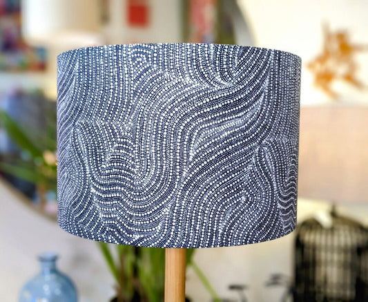 Desert Dreaming lampshade by Emotive Collection, featuring an Aboriginal design by Warlukurlangu Artists. The monochrome colorway highlights intricate desert motifs. Handcrafted in Australia for a unique, culturally rich lighting piece