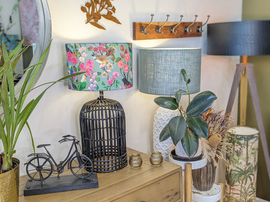 Birds and Blooms lampshade on a wooden sideboard, design by Cecilia Mok and made by hand by Emotive Collection, showcasing a beautiful blend of birds and flowers in an elegant design. Handmade in Australia.