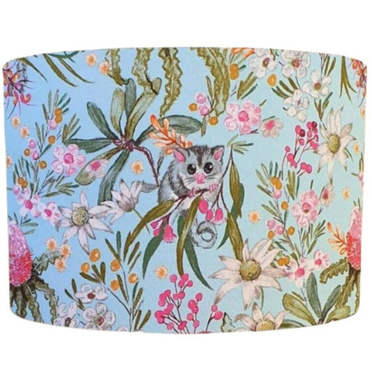 Blue Possum lampshade, designed by Australian artists, featuring a whimsical possum pattern in soft blue tones. Handcrafted in Australia by Emotive Collection.