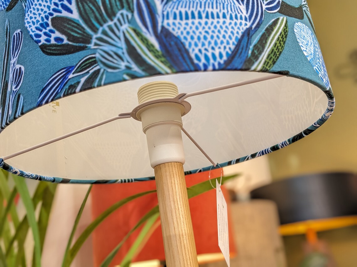 Banksias Blue lampshade with a striking design of Banksia flowers in vibrant blue hues, created by Kirsten Katz. Handmade in Australia by Emotive Collection.