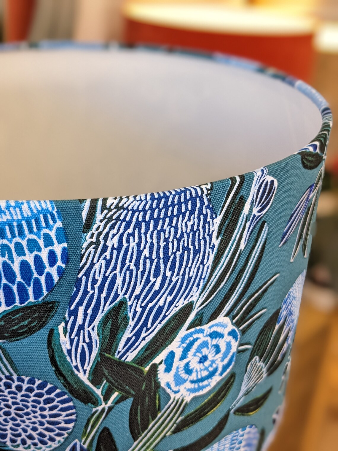 Handcrafted Banksias Blue lampshade by Emotive Collection, featuring a beautiful Banksia flower print in calming blue tones. Designed by Australian artist Kirsten Katz