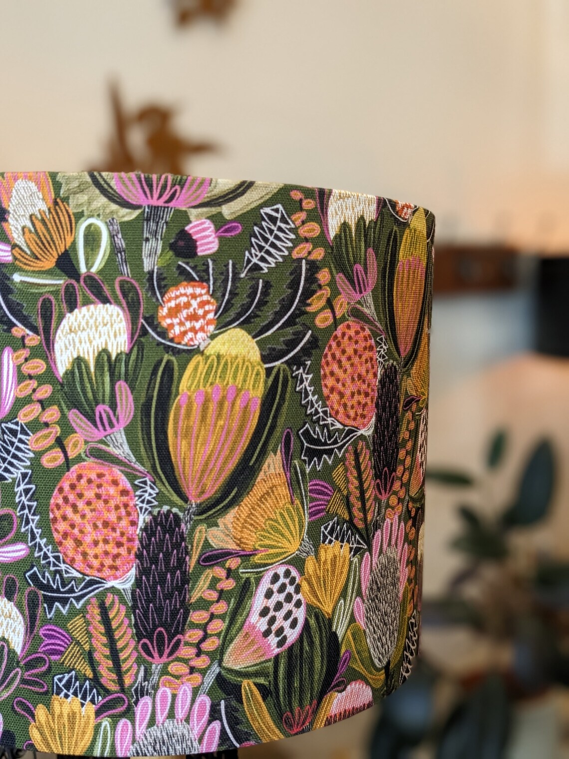 Side profile of Emotive Collection’s Handmade Bush Banksia lampshade features vibrant Banksia flowers in a green hue, designed by Australian artist Jocelyn Proust for a natural, artistic lighting solution.