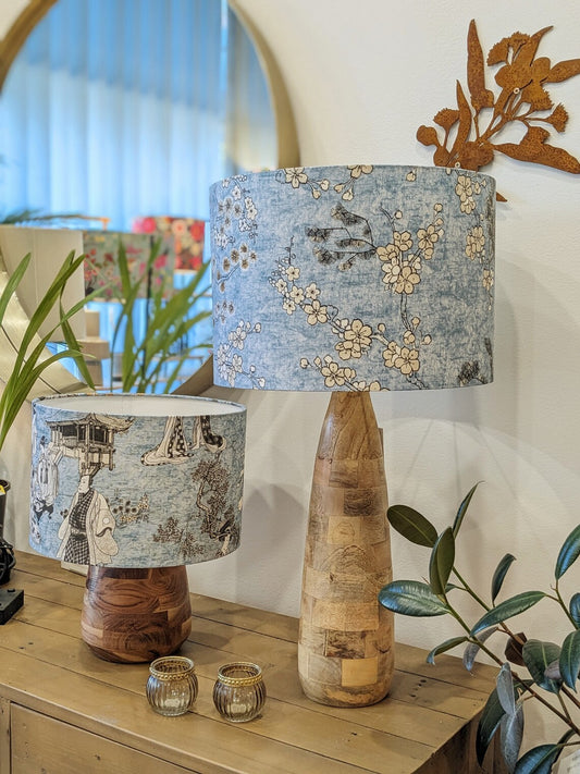 Handmade Japanese Blossom lampshade by Emotive Collection on a wooden lamp base, featuring soft blue tones and intricate Japanese floral patterns. Crafted with care in Australia for a serene and elegant touch