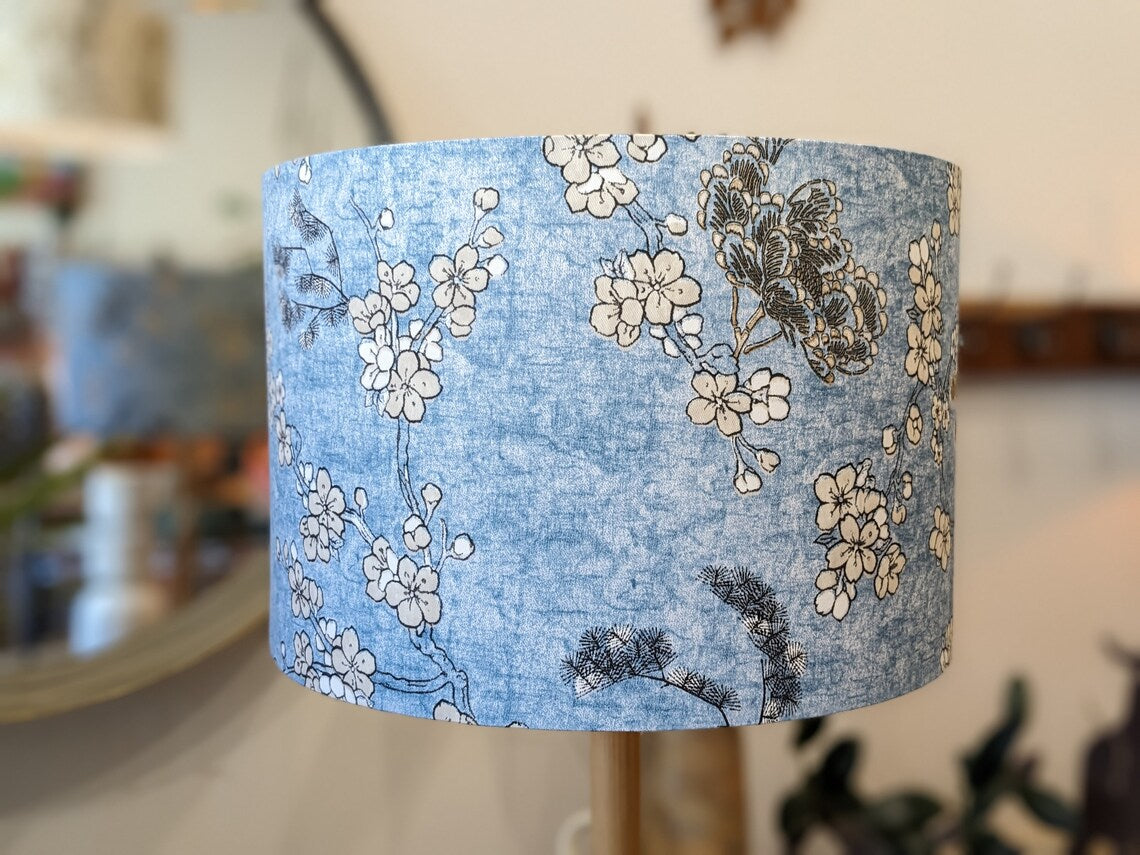 Close up of the Japanese Blossom lampshade by Emotive Collection, showcasing delicate blossoms on a calming blue background. Expertly handmade in Australia, this lampshade brings a peaceful ambiance to your space.