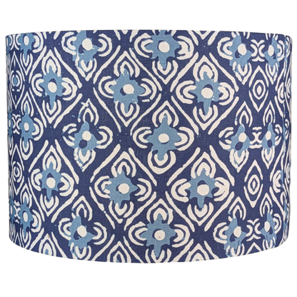 The Amaya Indian Block Print Lampshade by 100% Premium Linen features a cylindrical shape and blue and white geometric floral pattern with repeating diamond and flower motifs.