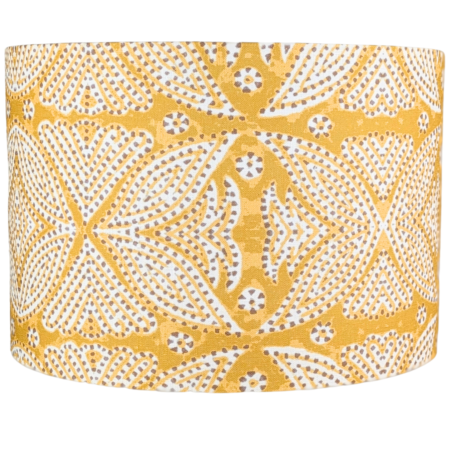 The Leela Indian Block Print Lampshade by 100% Premium Linen is a drum-shaped, handcrafted linen shade, featuring yellow fabric with white and brown geometric dot and floral patterns.