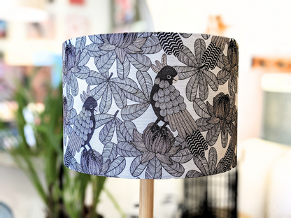 The Emotive Collection’s Australian Cockatoo Lampshade showcases a detailed black and white bird and leaf pattern by an Australian designer, with a softly blurred backdrop highlighting its intricate, almost abstract design.