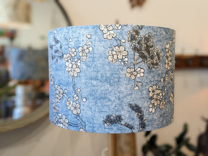 Close up of the Japanese Blossom lampshade by Emotive Collection, showcasing delicate blossoms on a calming blue background. Expertly handmade in Australia, this lampshade brings a peaceful ambiance to your space.