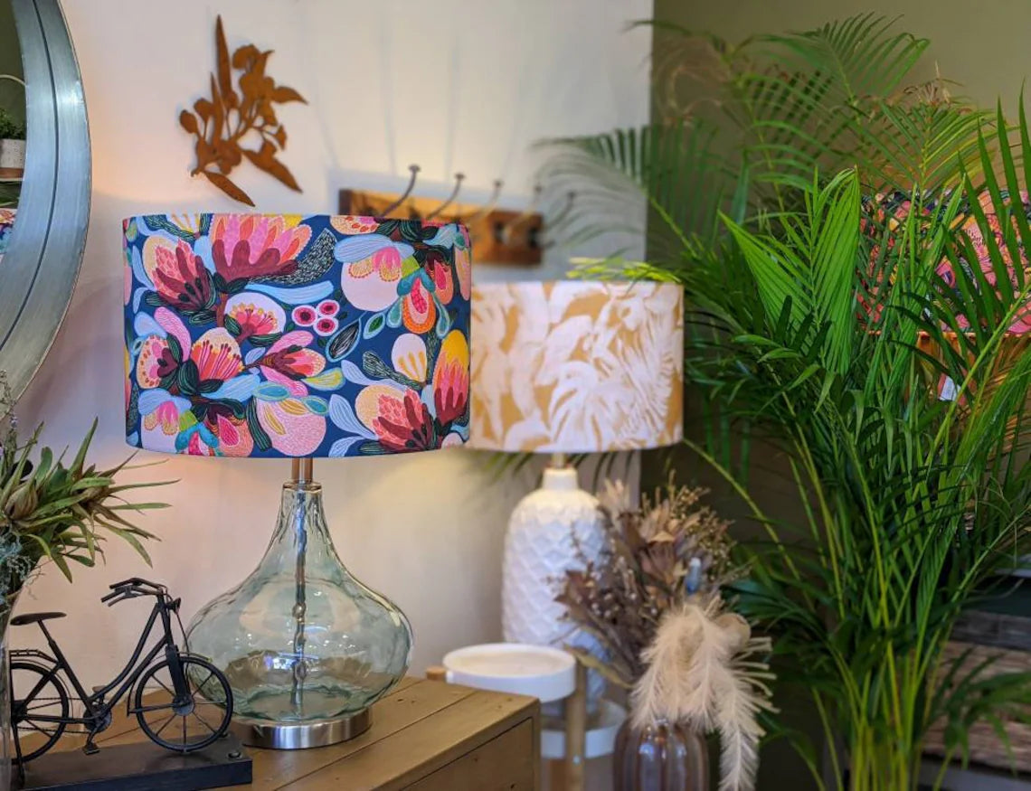 Midnight Bush lampshade by Emotive Collection on a glass lamp base, showcasing native Australian flora in a stunning design by Kirsten Katz. Expertly handmade in Australia, adding a unique touch of Australian artistry to your home.