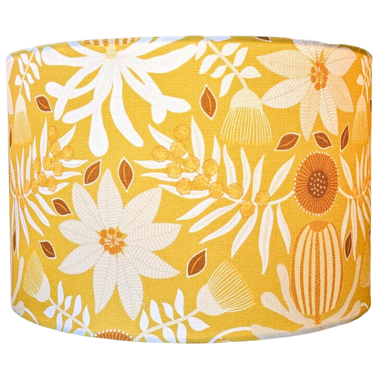 Emotive Collection’s Native Flora Mustard Lampshade, featuring white and Orange floral and leaf patterns on a Mustard background by Jocelyn Proust.