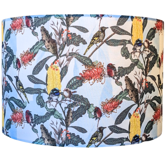 The Emotive Collection’s Yellow Banksia & Native Birds Lampshade is handmade with a vibrant design of native birds and banksia on white, creating a lively and colorful accent for any space.
